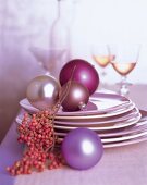 Multi-coloured baubles on a stack of plates