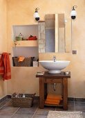 Vanity sink on wooden table with wall mirror