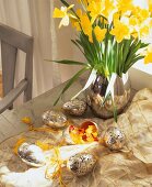 Egg vase made of stainless steel with daffodils and silver decorated eggs