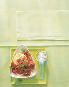 Spaghetti pasta with tomatoes and pine-seeds on plate