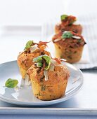 Parmesan muffins garnished with herbs on plate