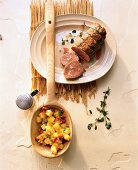 Bouillon potatoes in wooden spoon with veal fillet in mustard-herb sauce