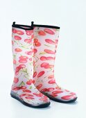 Rubber boots with printed with red cherries on white background