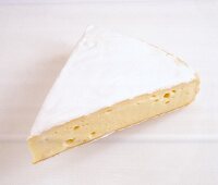 Close-up of brie on white background