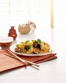 Fried noodles and crisp vegetable on plate with chopsticks