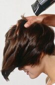 Close-up of woman with garcon cut hair getting her hair blow dried