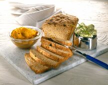 Homemade buckwheat bread with knife on chopping board