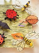 Close-up of homemade beetles and dragonfly made of paper