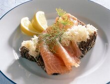 Close-up of bread with salmon and lemon on plate