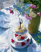 Cup cakes and biscuits in cake stand on wedding table