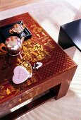 Chinese style red coffee table with golden paintings, elevated view