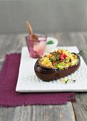 An aubergine filled with couscous and vegetables