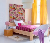 Colourful bedroom with chair, curtains and floral patterned fabric covered frame