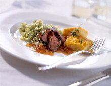 Close-up of wild duck breast with walnut quince sauce and polenta