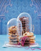 Christmas cookies in glass dome bell jars against blue background