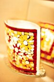 Close-up of mosaic lamp with floral designs of red and yellow sherds