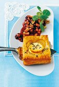 A puff pastry onion tart served with cranberry compote and thyme