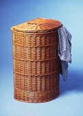 Wicker laundry basket against blue background