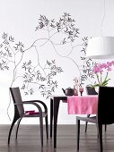Dining room with black and white floral wallpaper and dining table