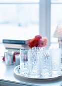 Silver tray with glasses on window sill