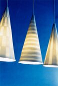 Three porcelain pendant lights with various designs on blue background