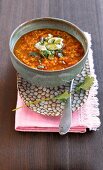 Red lentil soup spiced with Indian chilli, garam masala and turmeric in bowl