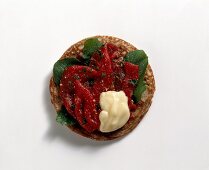Blinis with rocket, beef and lemon mayonnaise on white background