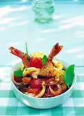 Tomato and bread salad with fried prawns in serving bowl