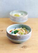 Chicken and coconut soup in bowl