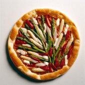 Pizza topped with green and white asparagus on white background