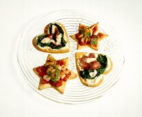Heart and star shaped pizzas on glass plate