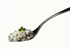 Risotto with parmesan cheese and basil on white background