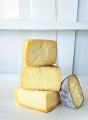 Stack of different types of cheese on white table, Campania, Southern Italy