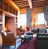 Lounge of hotel with fireplace, chairs and sofa in Orsan near Bourges, France