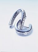 White gold earrings with diamonds on white background
