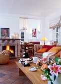 Living room with fire place, sofa, cushion and flower vase on wooden table