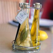 Close-up of oil and vinegar bottle on silver holder