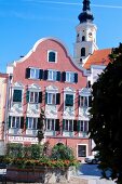 Facade of a old red house with white window and stucco, Passau, Germany