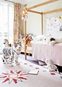 Bright bedroom with wooden bed and many stuffed animals