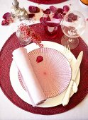 Table decorated with berries and rose petals, elevated view