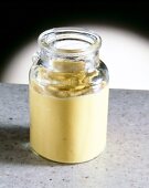 Close-up of yellow horseradish mustard in glass jar