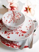 Close-up of red and white porcelain with floral decor