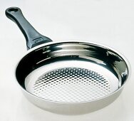 Close-up of stainless steel pan on white background
