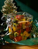 Pickled peppers and feta cheese in glass jar wrapped as gift