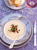Parsnip soup with thyme and apples on plate