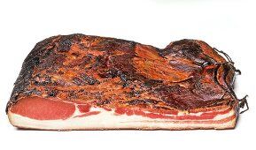 Close-up of Carinthian bacon on white background