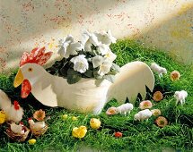 Handmade cock, sheep and chick with flowers in grass