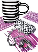 Black and white striped handbags on purple paper strips