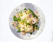 Pasta salad with snow peas and mushrooms on plate