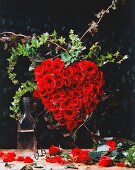 Heart shaped flower arrangement with red roses